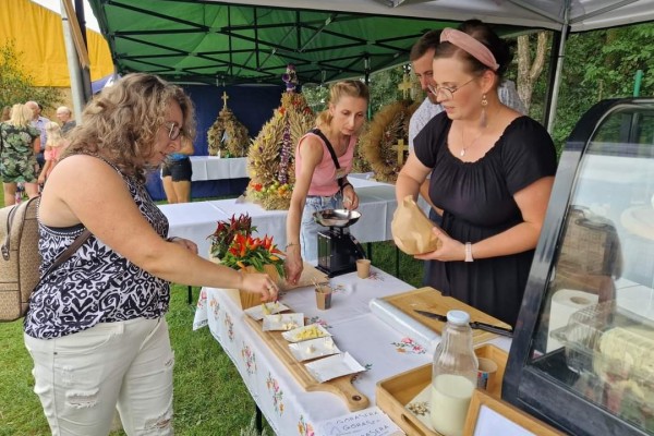 Osoby degustują sery na stoisku Góry Sera podczas dożynek