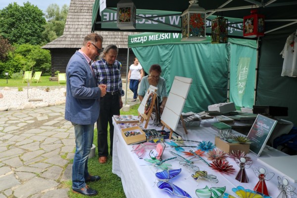 Wicestarosta pszczyński przy stoisku z wyrobami ze szkła.